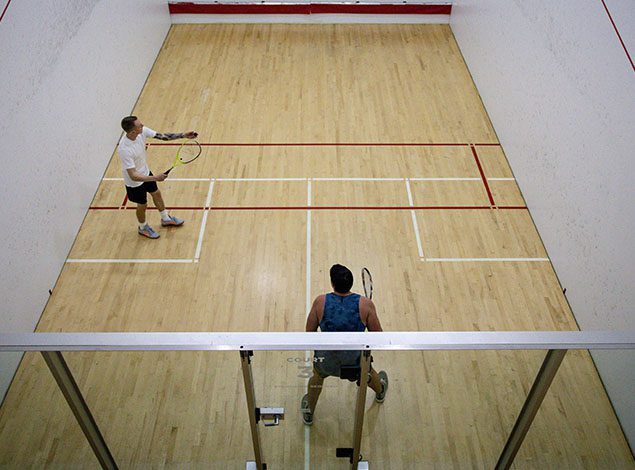 people playing racquetball in a modern gym