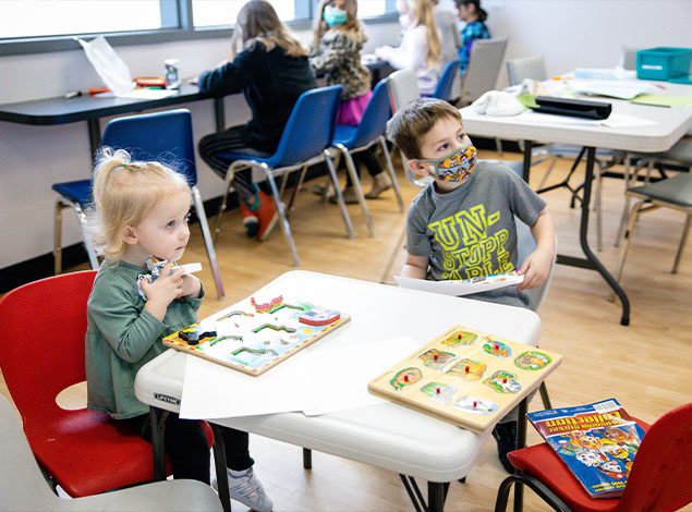 kids playing in dedicated childcare room in modern gym