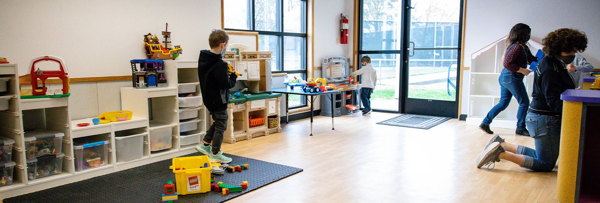 kids playing in dedicated childcare room in modern gym